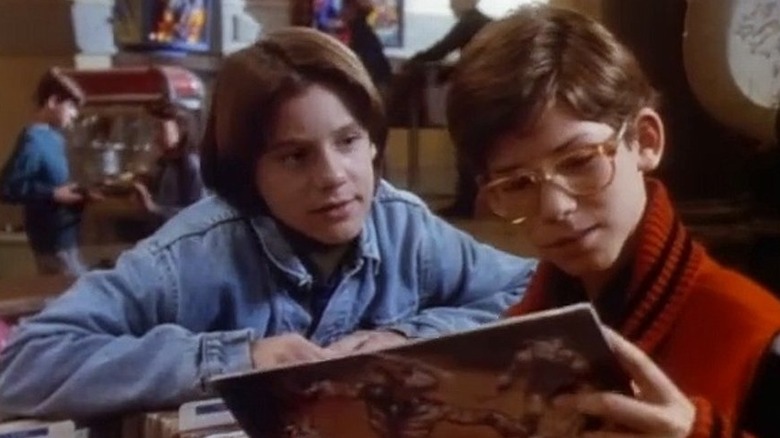 Marshall (Omri Katz) and Tod (Grant Gelt) looking at a record on 
