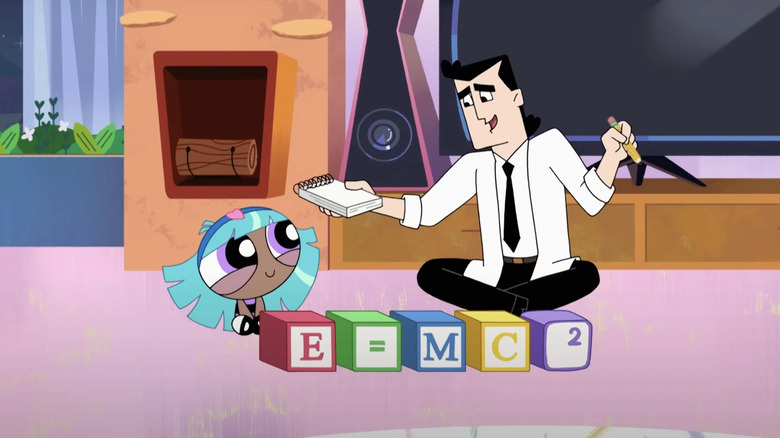 A young Bliss and Professor Utonium sitting together behind a set of blocks that read 