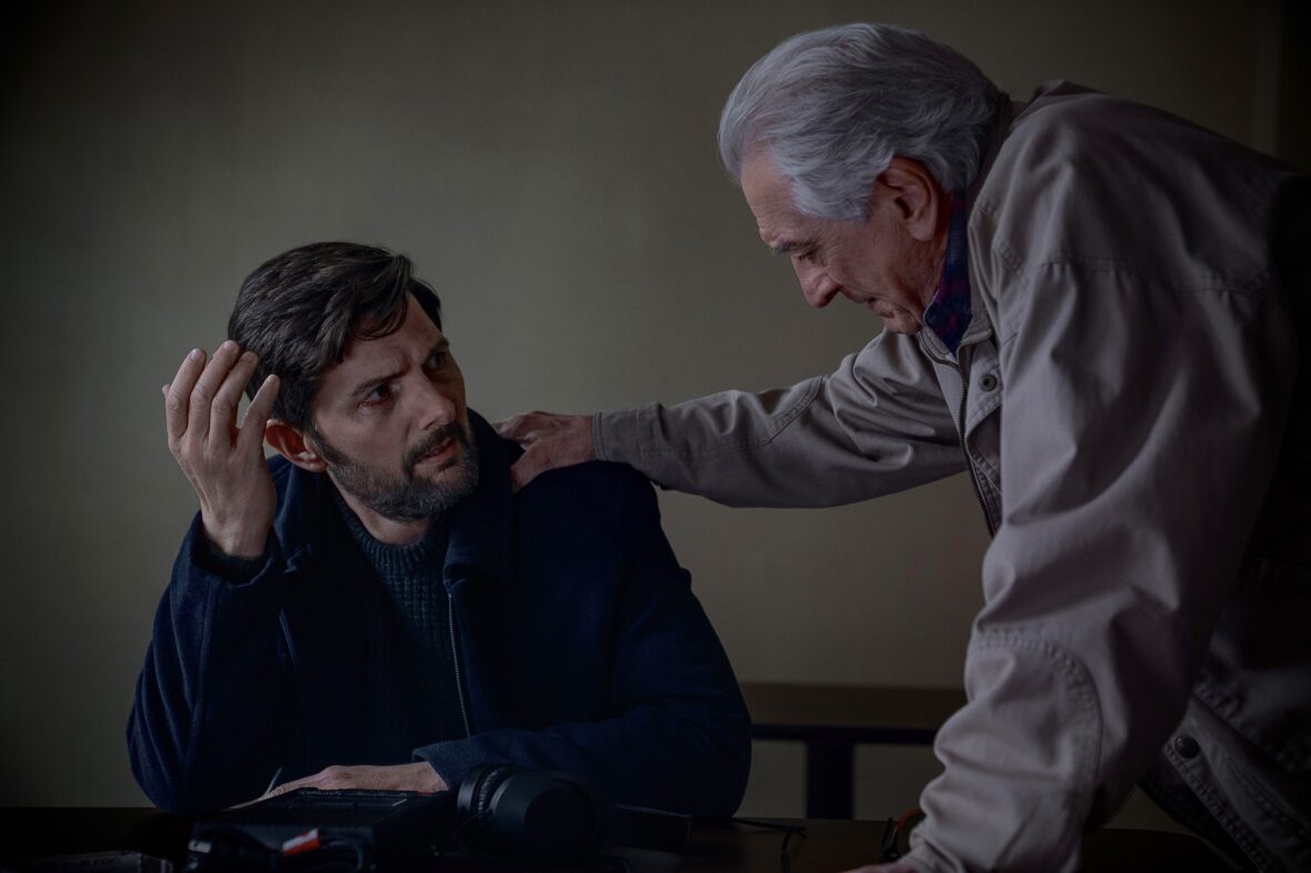 Robert De Niro puts a hand on Adam Scott's shoulder in still from "The Whisper Man."