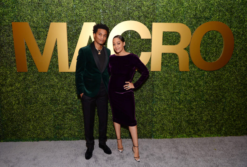Tia Mowry and Cory Hardrict pose for a photo together in front of Macro logo.