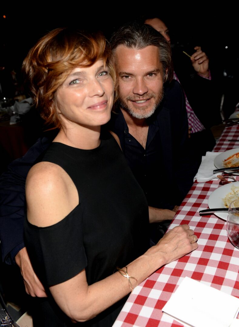 Timothy Olyphant and wife Alexis Knief pose for a photo together at a casual dinner event.