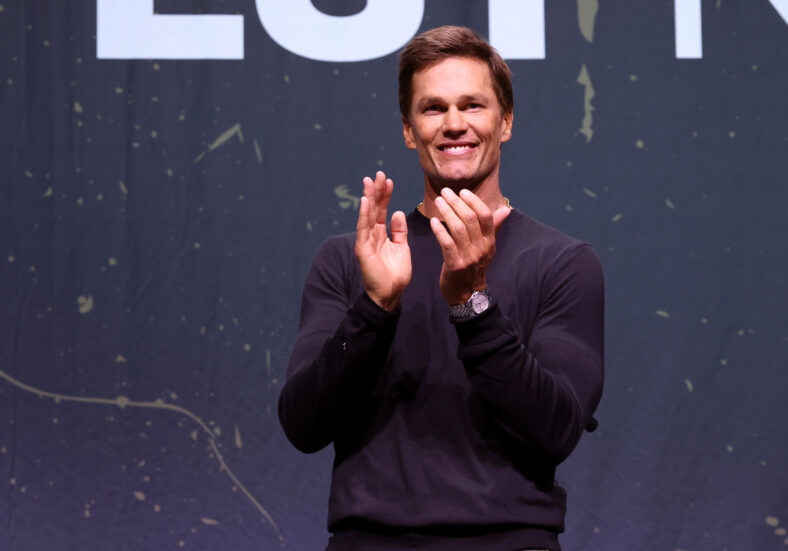 A medium shot of Tom Brad mid-clap at the Fanatics Fest.
