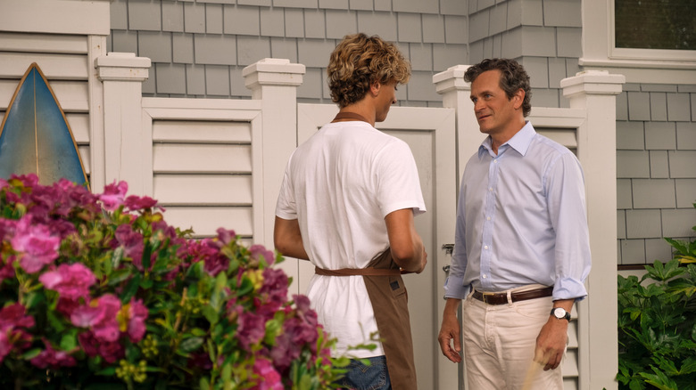 Tom Everett Scott as Adam Fisher speaking to Gavin Casalegno as Jeremiah Fisher outside of a beach house in 